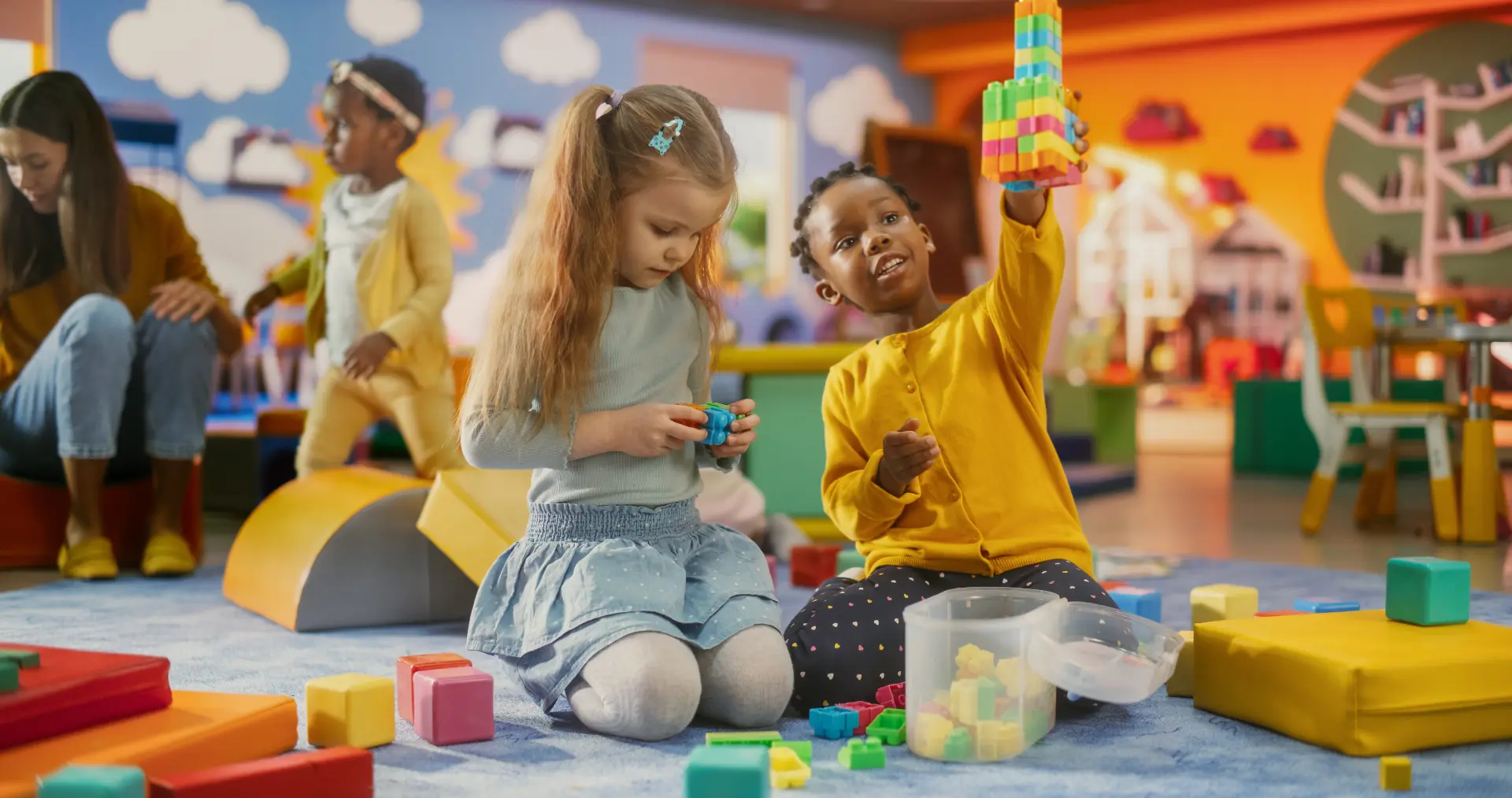 Bright, welcoming Discovery Time classroom with colorful rugs, toys and learning stations